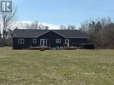 Spacious 3-bedroom, maintenance-free bungalow on a serene 14-acre parcel, showcasing an expansive op...