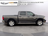The 2022 Ram 1500 Classic SLT 4x4 Crew Cab stands out with its sophisticated gray exterior and power... (image 1)