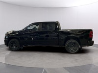 The 2026 Ram 1500 Big Horn, presented in a commanding Black finish and equipped with a robust 4x4 dr... (image 1)