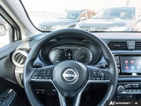 The former daily rental 2024 Nissan Versa SV, dressed in an eye-catching Aspen White TriCoat, presen... (image 6)