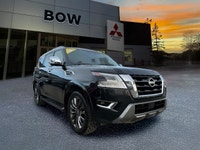 The 2023 Nissan Armada 4x4 Platinum in a striking black finish is a powerhouse SUV designed for both... (image 2)