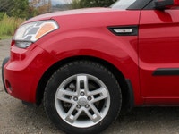 The 2011 Kia Soul 2u in a vibrant red with front-wheel drive is a vehicle built for handling the dem... (image 7)