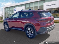 Experience enhanced visibility and an open-air feel in this stunning red 2021 Nissan Rogue SV, featu... (image 2)
