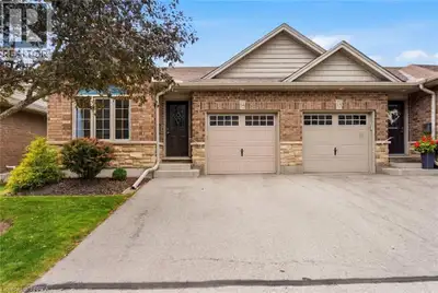 Welcome to 560 Grey Street, Unit 14—a beautifully maintained end-unit bungalow townhouse condominium...