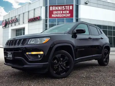Step into the commanding presence of the 2018 Jeep Compass Altitude 4x4, cloaked in a stunning black...