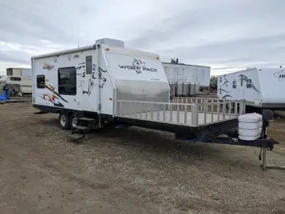 18ft camper plus toy hauler section up front. Tandem axle. new batteries. propane working. awning. c...