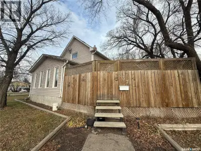 Super charming one and a half storey home in Estevan with a large fenced in deck and patio area perf...