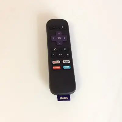The Roku remote control shown in the image does not have a microphone button. This is a "simple" rem...