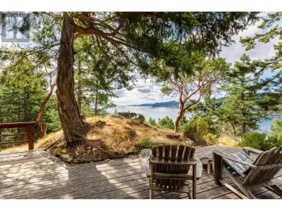 Sandy beach, extraordinary views, and park-like trails, is what this 2.18 acre waterfront property i...