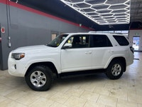The 2015 Toyota 4Runner 4WD 4dr V6 SR5, in its striking White exterior paired with a robust 44 drive... (image 1)