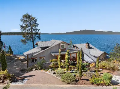 INCREDIBLE VIEWS! Perfectly sited on .865 of an acre on the waterfront in the prestigious, gated com...