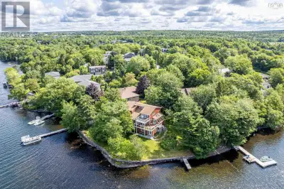 Welcome to 30 Sunset Drive, where European-inspired elegance meets peaceful lakefront living on beau...