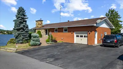 What a View!! Beautiful Landscaped waterfront with a breathtaken view of the Laurentian mountains ....