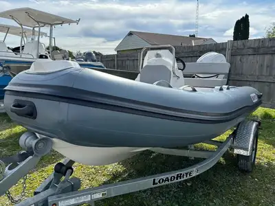 New Apex A-12 Inflatable Boat power matched with a Tohatsu 25 HP and Load Rite Trailer. Picture show...
