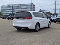The 2026 Chrysler Grand Caravan SXT in Bright White with a Black interior combines modern styling, e... (image 6)