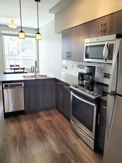 This modern semi-furnished 2 bedroom 2 bathroom townhouse is located at 202-110 Baxter Landing, Kiti...