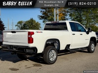 The 2026 Chevrolet Silverado 2500HD Work Truck in pristine white and equipped with a rugged 4x4 driv... (image 3)