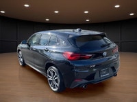 The 2022 BMW X2 xDrive28i Sports Activity Coupe in a sophisticated black finish and equipped with BM... (image 5)