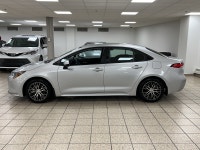 Dawn paints the streets in quiet silver as the 2021 Toyota Corolla L slips from the curb, its LED be... (image 2)