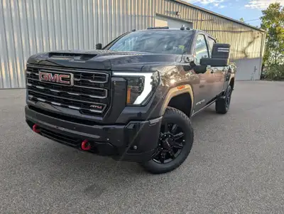 Presenting the 2025 GMC Sierra 3500HD AT4, dressed in a distinguished gray with a robust 44 drivetra...