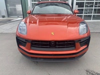 The 2023 Porsche Macan AWD, finished in eye-catching Papaya Metallic, brings true sports car DNA int... (image 1)
