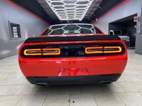 Meet the 2022 Dodge Challenger GT in a vibrant orange finish, gracefully combined with an AWD drivet... (image 6)