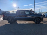 The 2026 Ram 1500 Rebel Crew Cab in Granite Crystal Metallic makes a bold statement with its rugged... (image 7)