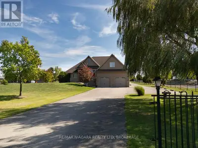 Sprawling 3-bedroom, 2.5-bathroom bungalow situated on a 1.37-acre lot enclosed by elegant black met...