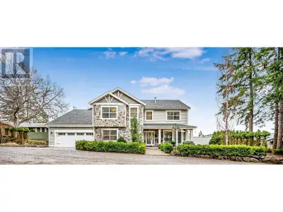 This custom-designed executive residence, perched in prestigious Lakeview Heights, offers an excepti...