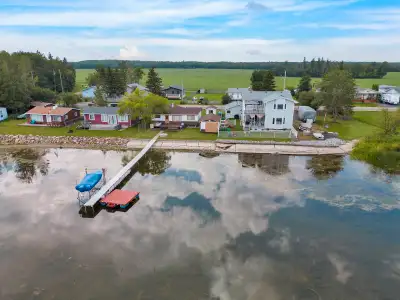 LAKEFRONT views from every window! This updated two-story home is nestled on a spacious double lot i...