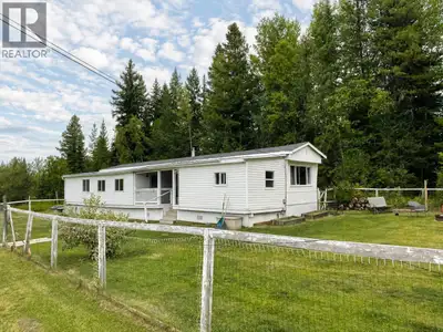 Affordable acreage with plenty of potential! This 3+ bedroom, 2 bath manufactured home with a spacio...