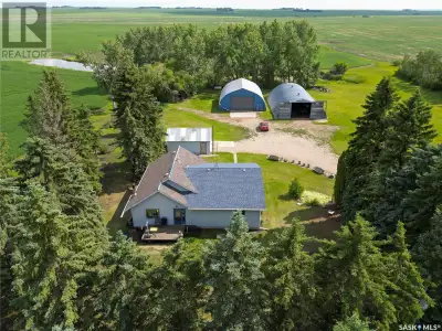 Spacious 1676 bungalow nestled in a well-groomed 10/acre yard site with a Sask. Water Pipeline. Feat...
