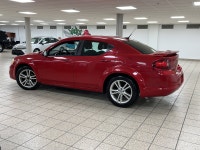 A red 2011 Dodge Avenger SXT easing through the day has a way of making routine driving feel more de... (image 2)