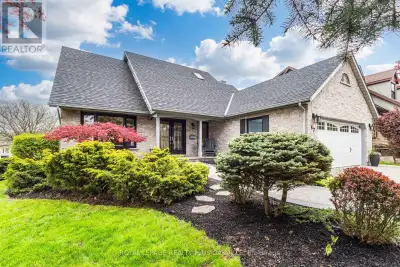 Tucked into a quiet, established neighbourhood on a mature corner lot, surrounded by trees and steps...