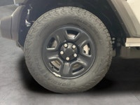 The 2026 Jeep Wrangler Sport 2 Door 4x4, presented in a striking white color, is equipped with a res... (image 8)