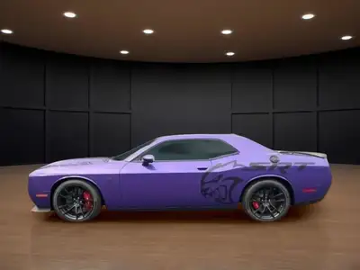 The 2023 Dodge Challenger SRT Hellcat Jailbreak in a stunning purple hue captivates with its rear-wh...