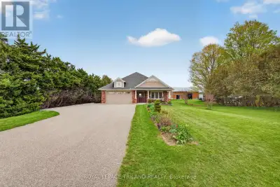 Nestled on just over half an acre and backing onto peaceful farm fields, this warm and welcoming bun...