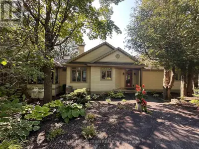Custom-built by renowned craftsman Claude Garand, this beautifully maintained bungalow sits on a bre...