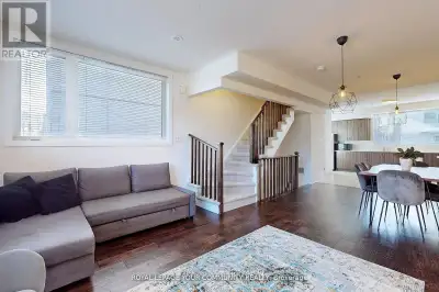 MOVE IN READY!! This stunning corner-unit townhouse is bathed in natural light and overlooks a seren...