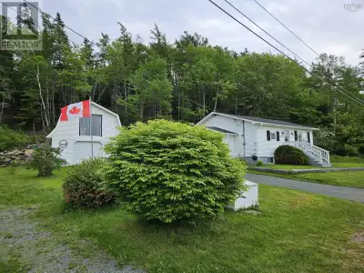 Charming 2-bedroom, 1-bathroom bungalow with a paved driveway and spacious two-story garage, nestled...