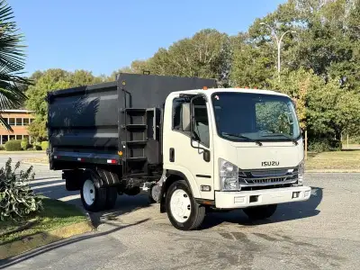 This 2017 Isuzu NPR HD dump truck is powered by a 6.0L 8-cylinder engine paired with an automatic tr...