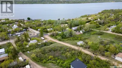 Escape to the serene shores of Saskatchewan Beach and imagine your perfect cabin perched on this inc...