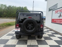 A rugged four-door SUV with iconic styling, manual transmission, and strong 4x4 capability, offering... (image 4)