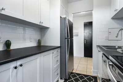 Fully renovated spacious suite features kitchen with modern features and finishes including laminate...