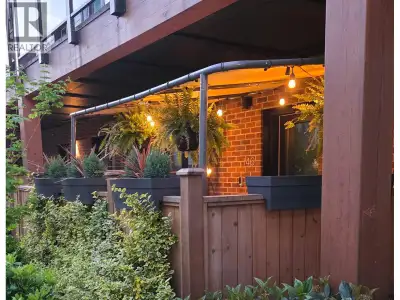 GARDEN-LEVEL END-UNIT at The Trails in Moodyville offering bright, open living and a private fenced...