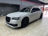 The 2023 Chrysler 300, particularly the 300C RWD in pristine white, is a powerful sedan that truly s... (image 1)