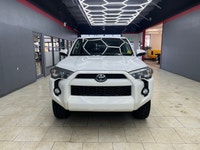 The 2015 Toyota 4Runner 4WD 4dr V6 SR5, in its striking White exterior paired with a robust 44 drive... (image 6)