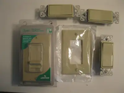 Leviton decor slide dimmer with preset switch. 3 decor switches.(used) 1 cover plate. All are almond...