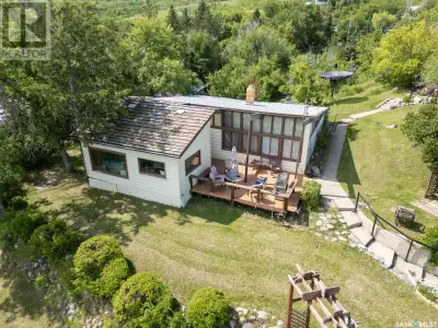 2 acres of LAKEFRONT on a hill overlooking Buffalo Pound Lake! 1870 square feet main (year round) ho...