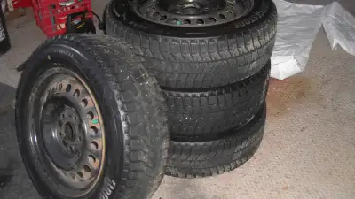 I HAVE FOUR BRIDGESTONE BLIZZAK M+S TIRES ON 5 BOLT RIMS FOR SALE--THE TIRES ARE 195-65-R 15 INCH--T...